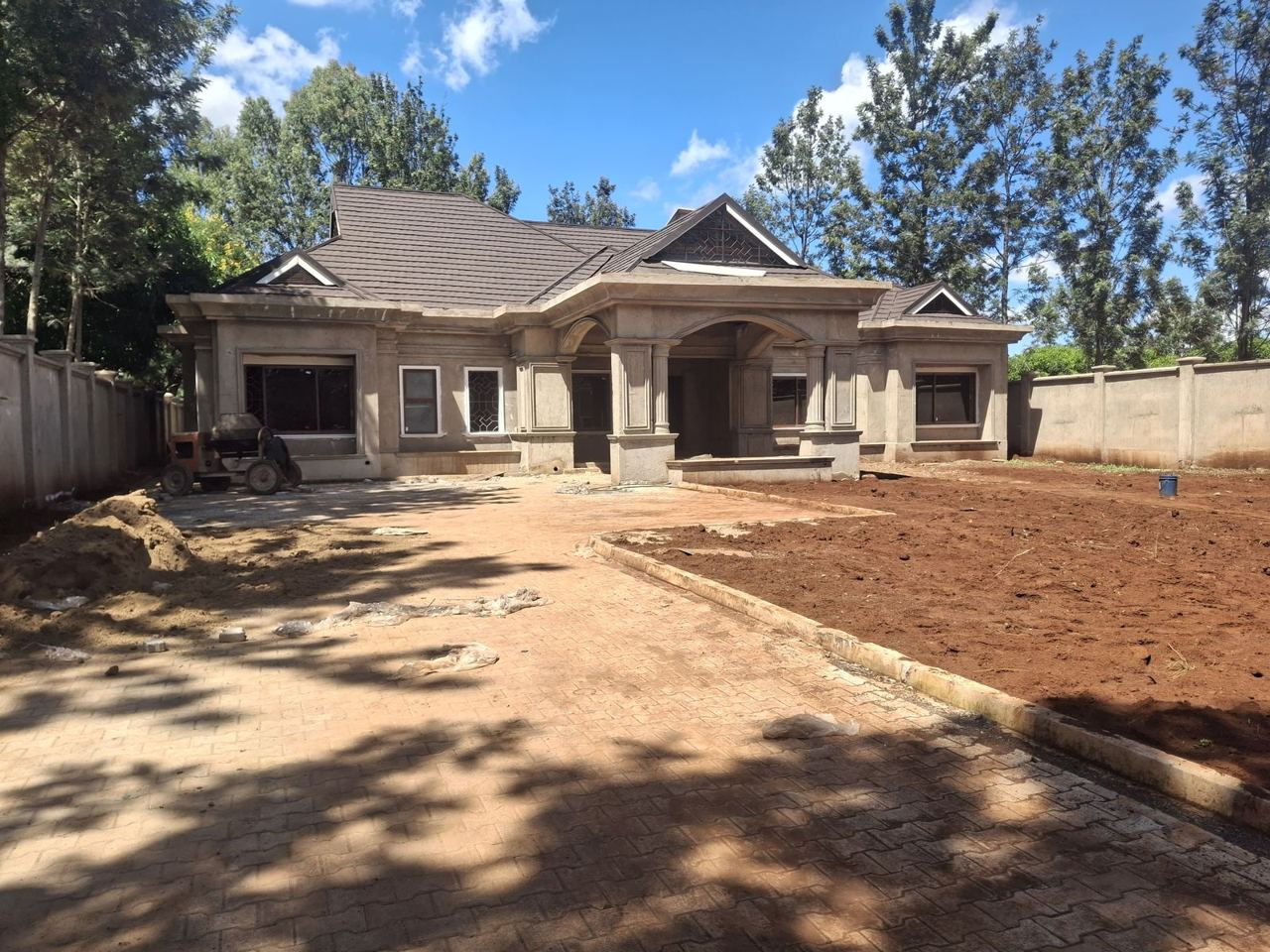 The Murang'a bungalow on site, plastered and roofed